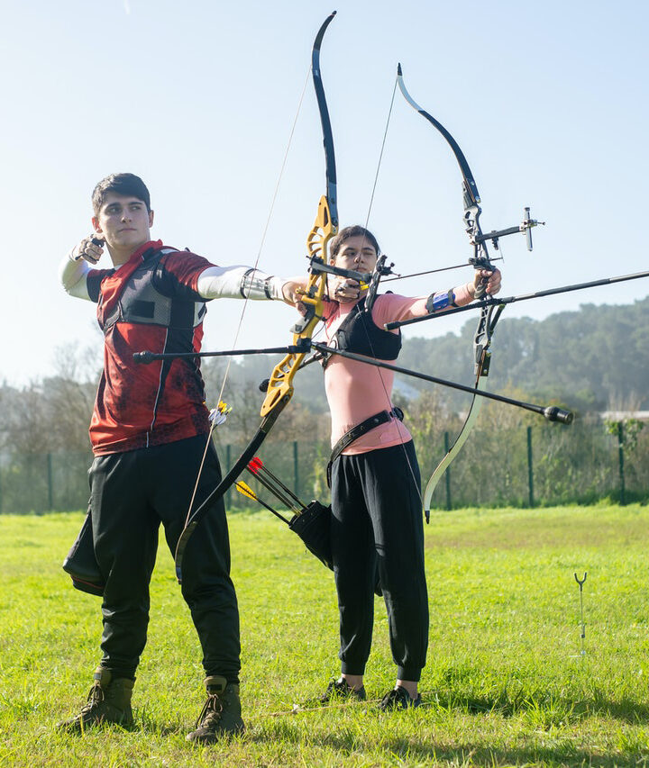 Why do archers wear shoulder pads?